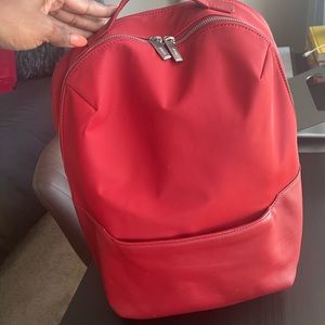 Red AWAY The Everywhere Zip Back pack in great condition with M monogram